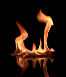 Fire with reflection on the dark background.